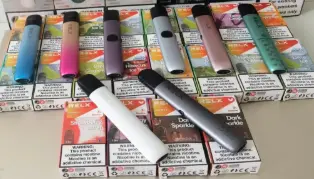 Seven pod devices laid in front of their RELX retail cartons, with English nicotine warnings